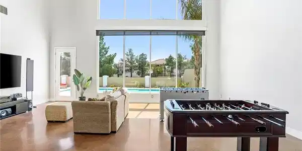 Image 2: Bright and airy living area with tall windows over