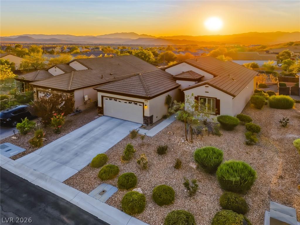 Image 2: Golden hour illuminates this desert home, showcasi