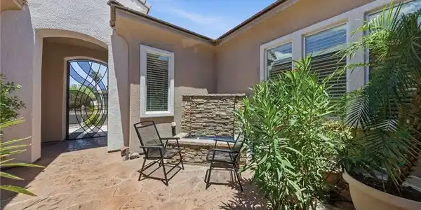 Image 3: An inviting courtyard entrance features a serene s