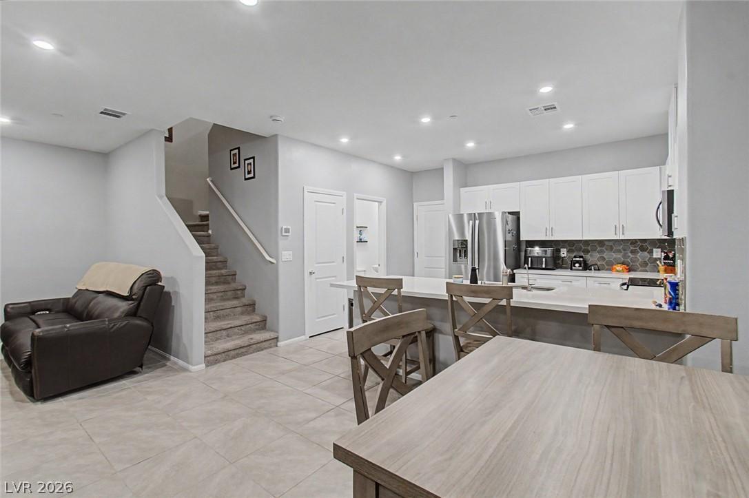 Image 3: A contemporary open-concept layout unites the kitc