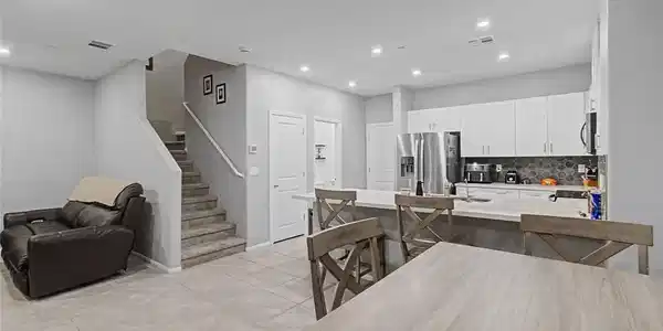 Image 3: A contemporary open-concept layout unites the kitc