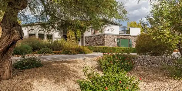 Image 3: Textured stone accents and desert landscaping defi