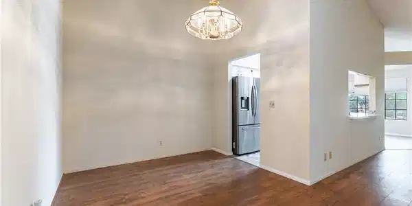Image 4: Vaulted ceilings and warm wood floors define this