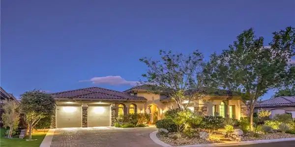 Image 2: Warm exterior lighting highlights this elegant des