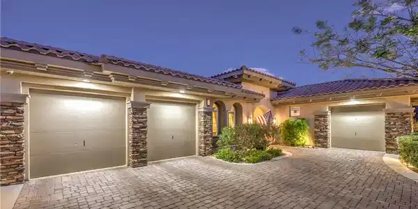 Image 4: An elegant paver driveway leads to a spacious mult