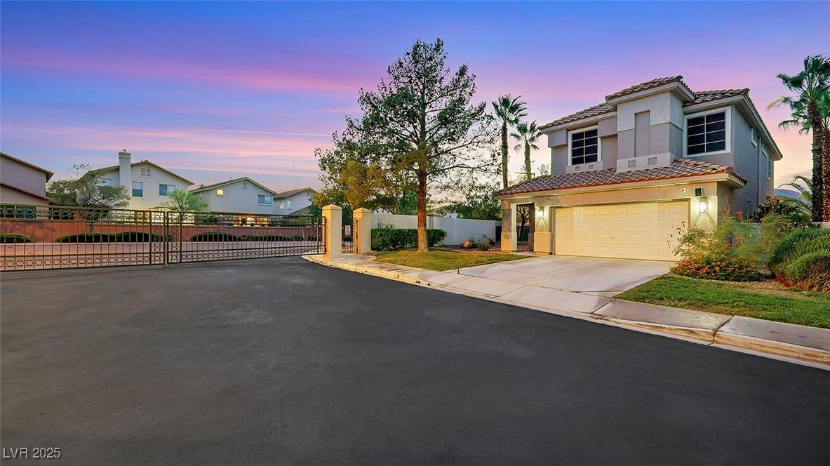 Image 2: View of front of home featuring driveway, a tile r
