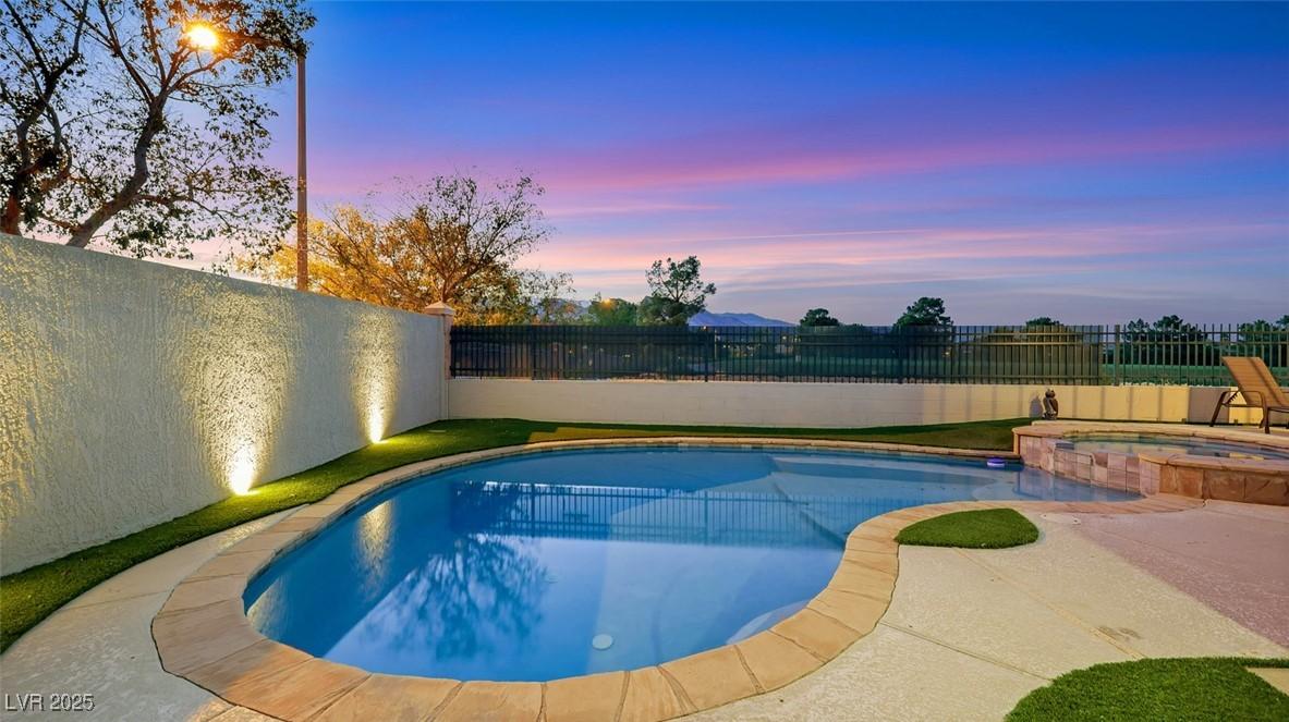 Image 4: View of pool with a fenced backyard, a pool with c