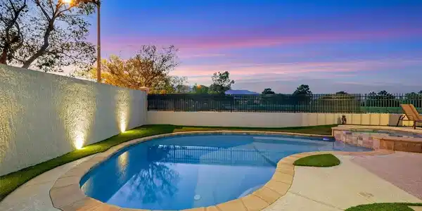 Image 4: View of pool with a fenced backyard, a pool with c