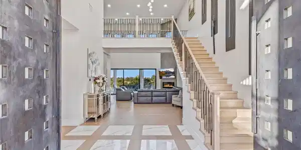 Image 2: This spacious foyer presents a grand entrance with