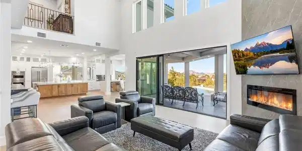 Image 3: This grand living space features high ceilings, an