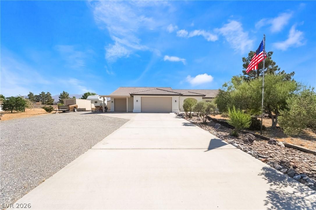 Image 2: A spacious home with an inviting driveway under a