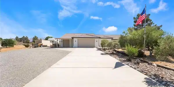 Image 2: A spacious home with an inviting driveway under a