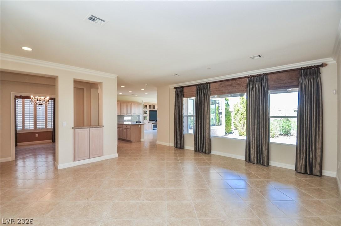 Image 2: An open floorplan living area features tile floori