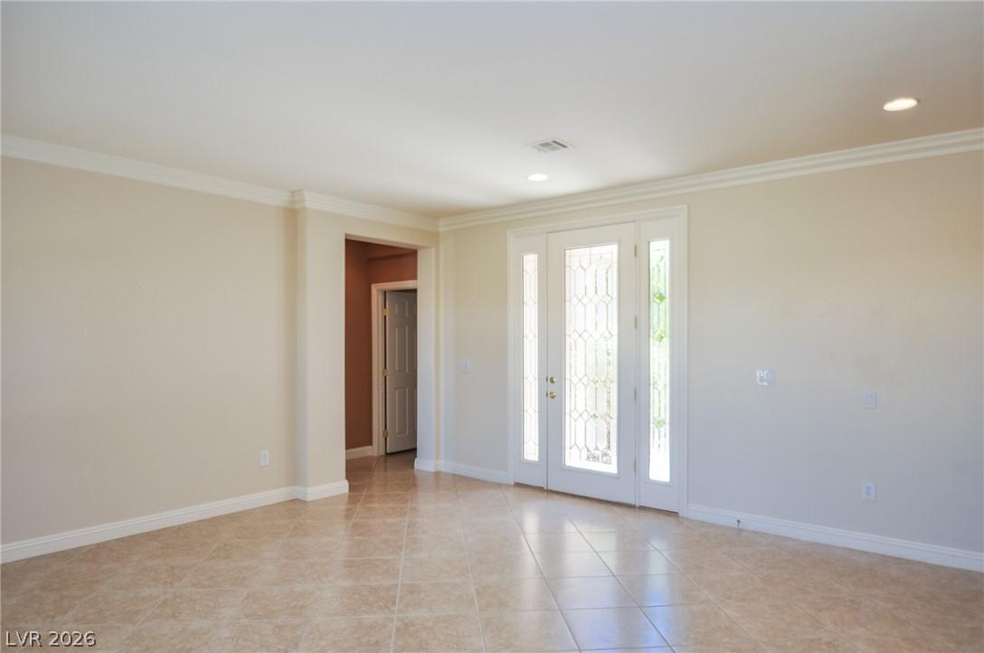 Image 3: A graceful entry with decorative glass doors, lead