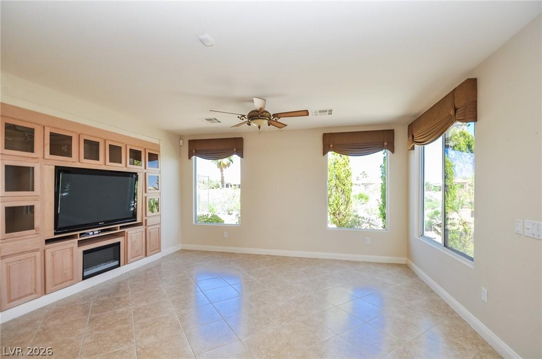 Image 4: A living area with built-in media center and ample