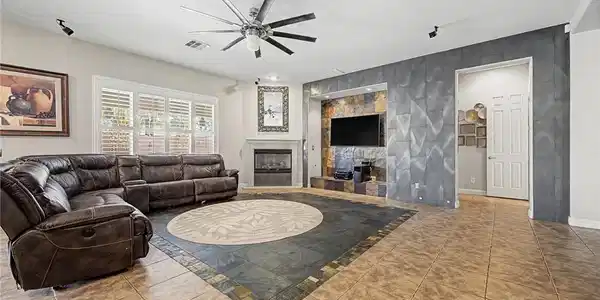 Image 2: An inset tiled floor borders the spacious living a