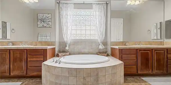 Image 4: Earth-toned tiles surround a deep soaking tub nest