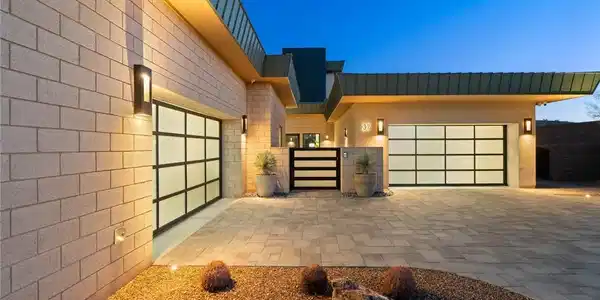 Image 3: A spacious paved motor court is flanked by contemp
