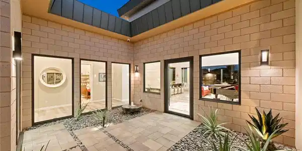 Image 4: An open-air courtyard features modern concrete blo