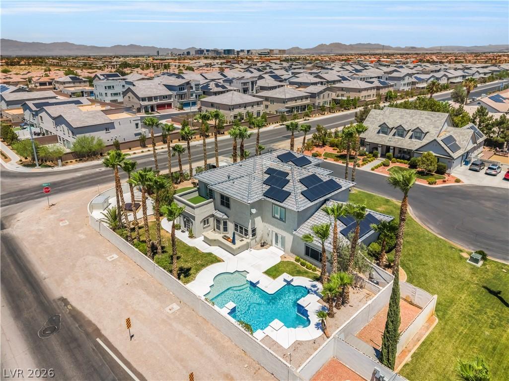 Image 1: An aerial perspective reveals a modern home with a