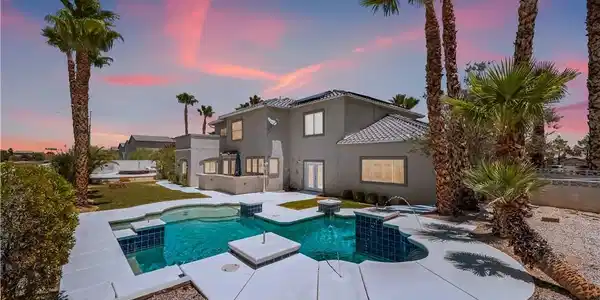 Image 2: An inviting backyard oasis awaits with a sparkling