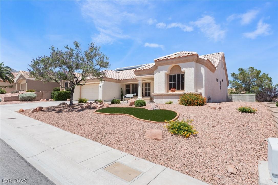 Image 3: A desert-friendly landscape surrounds this stucco-