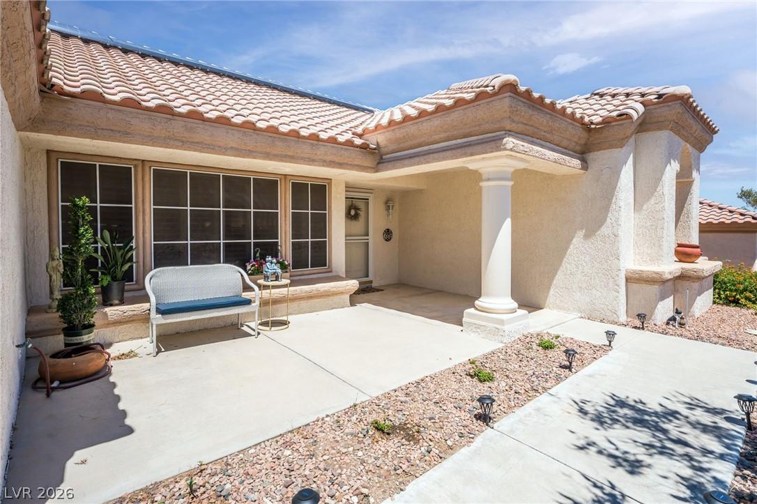 Image 4: A classic tiled roof crowns this inviting stucco h