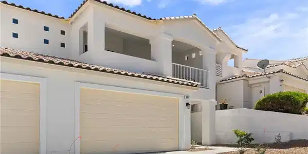Image 3: A striking stucco facade with tile roofing offers