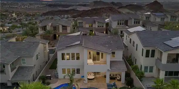 Image 2: Aerial shot of back of the home and mountain views