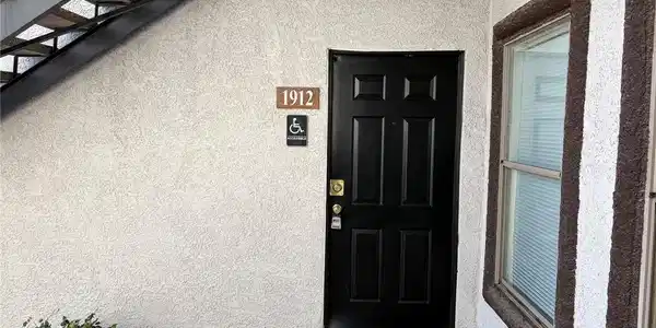 Image 2: An inviting private entrance features a bold black