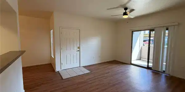 Image 3: Warm wood-look flooring and sliding glass doors en