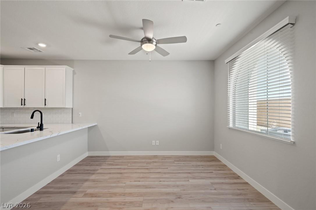 Image 2: This bright dining area features ample natural lig