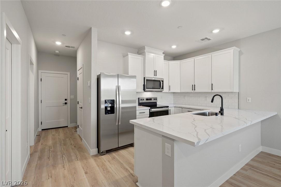 Image 3: Bright and open, this kitchen offers stylish finis