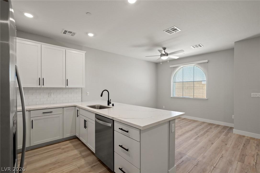 Image 4: This modern kitchen features a sleek island and am
