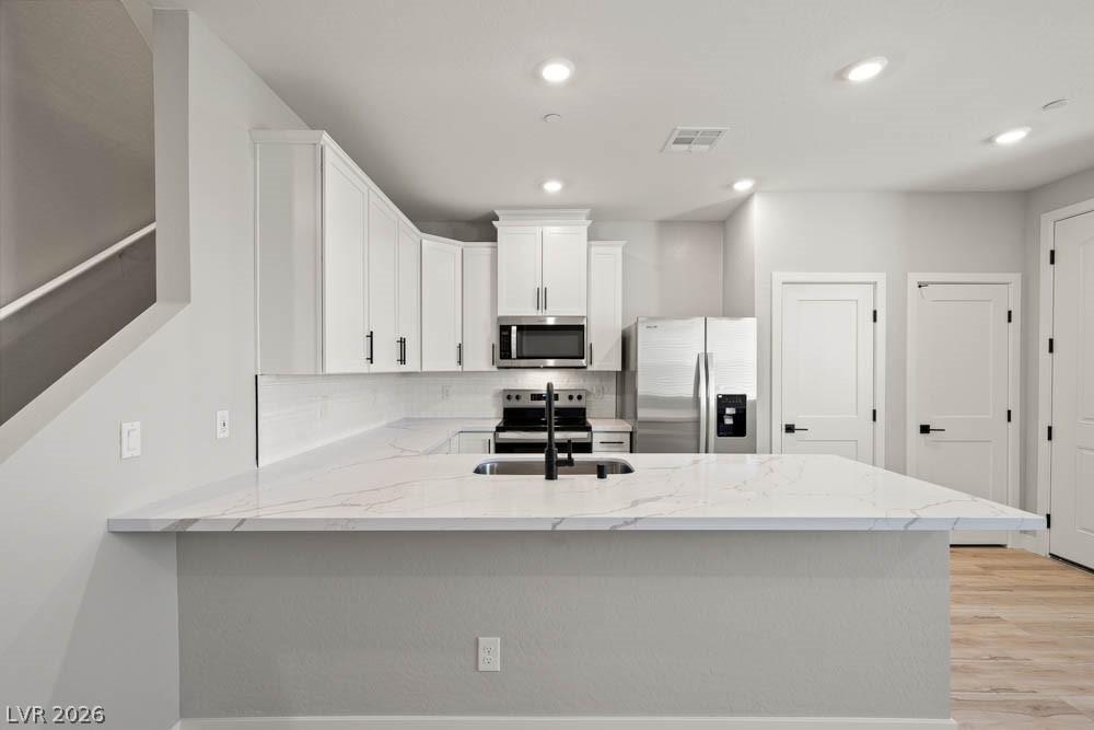 Image 2: This sleek kitchen features clean lines and modern