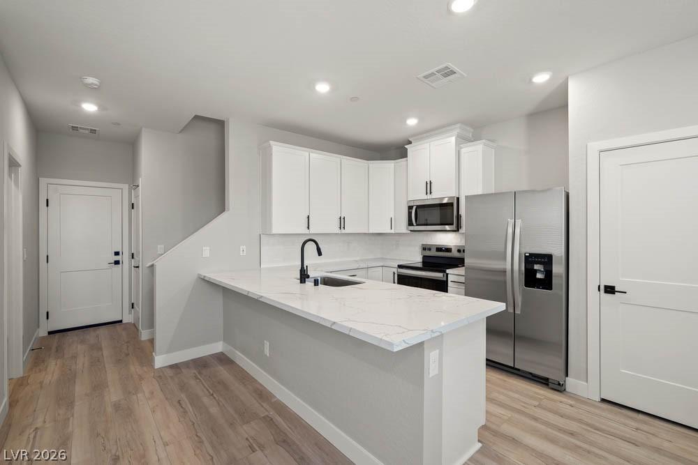 Image 3: This bright kitchen features sleek appliances and