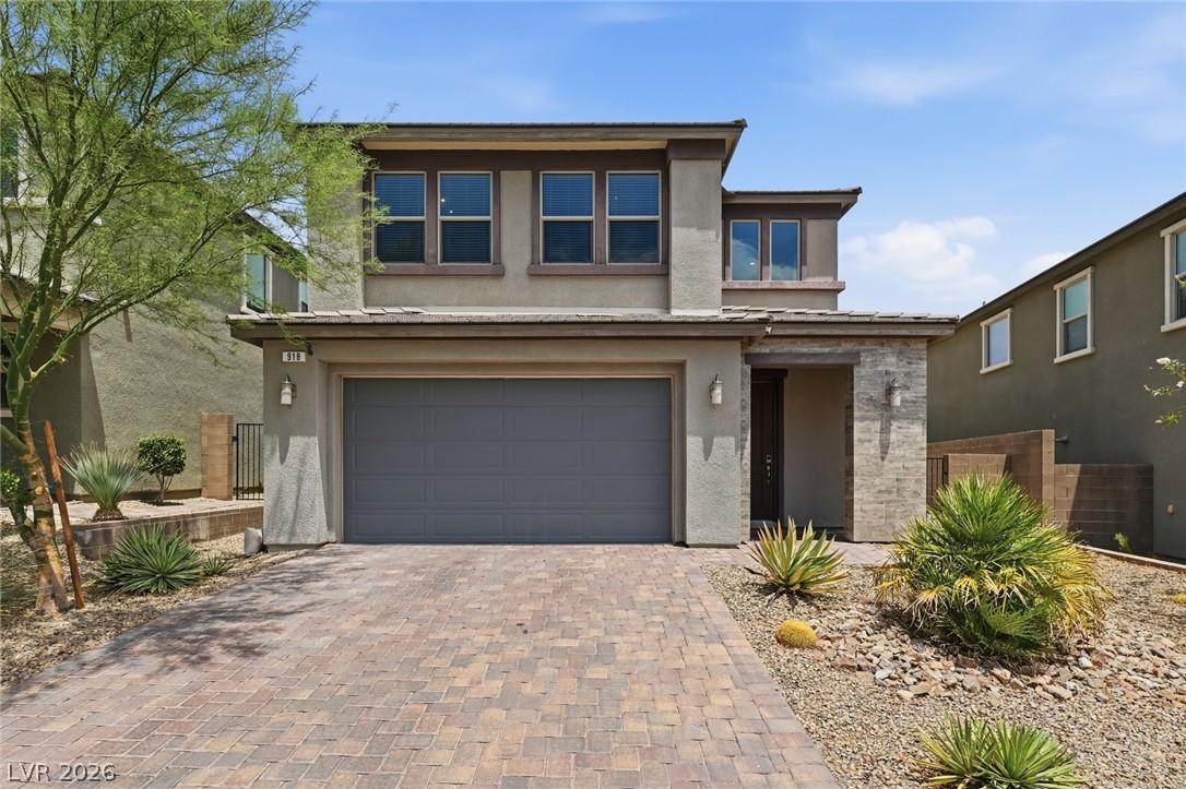 Image 3: A contemporary residence with a paver driveway, an