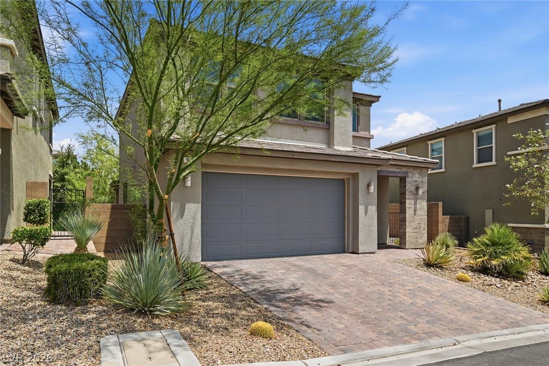 Image 4: A welcoming front entry features a paved driveway