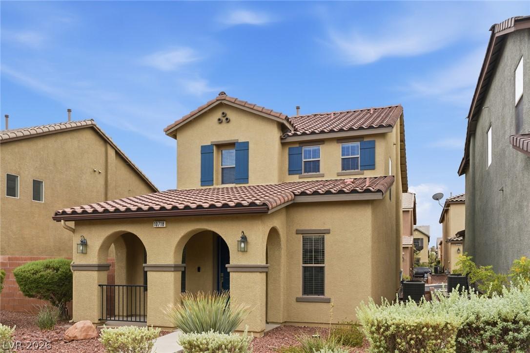 Image 3: A charming stucco exterior welcomes with blue shut