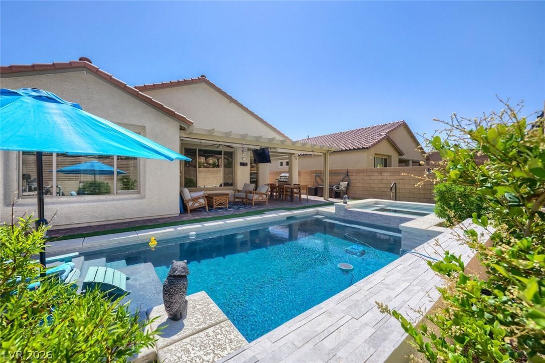 Image 1: This outdoor oasis features a refreshing pool and