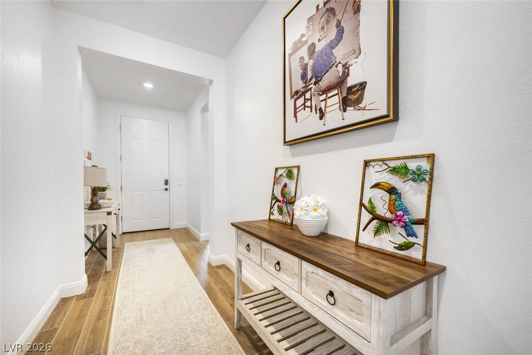 Image 3: This inviting hallway features bright walls and ri