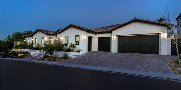 Image 4: A striking contemporary residence with a multi-car