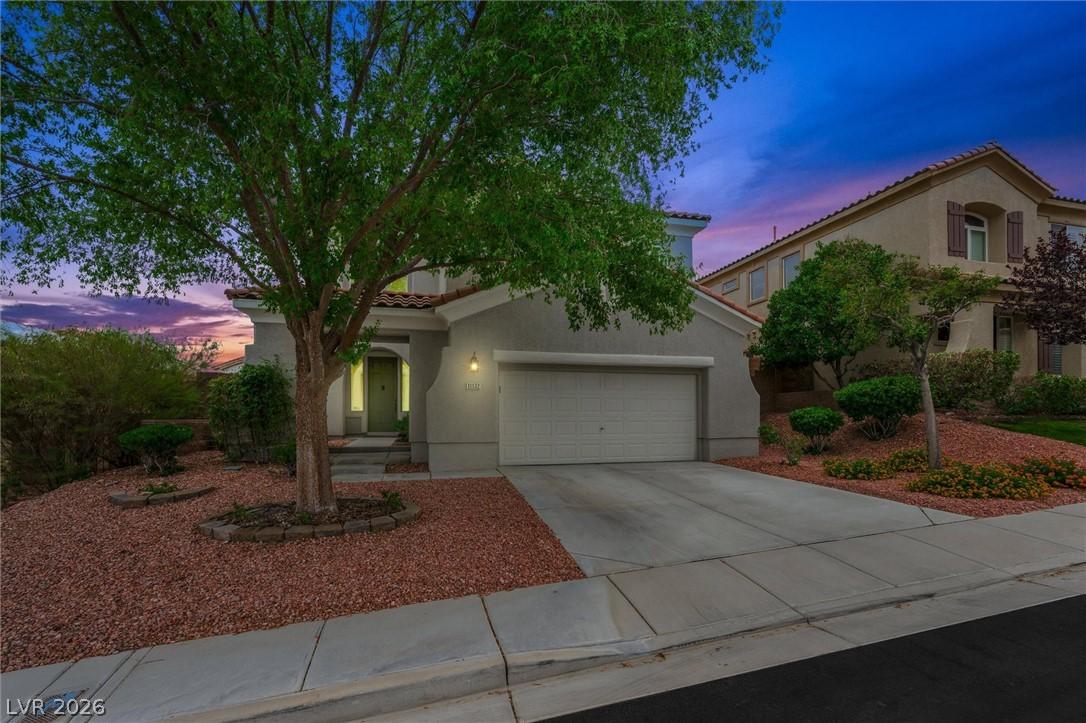 Image 2: Mature trees frame the inviting entryway of this c