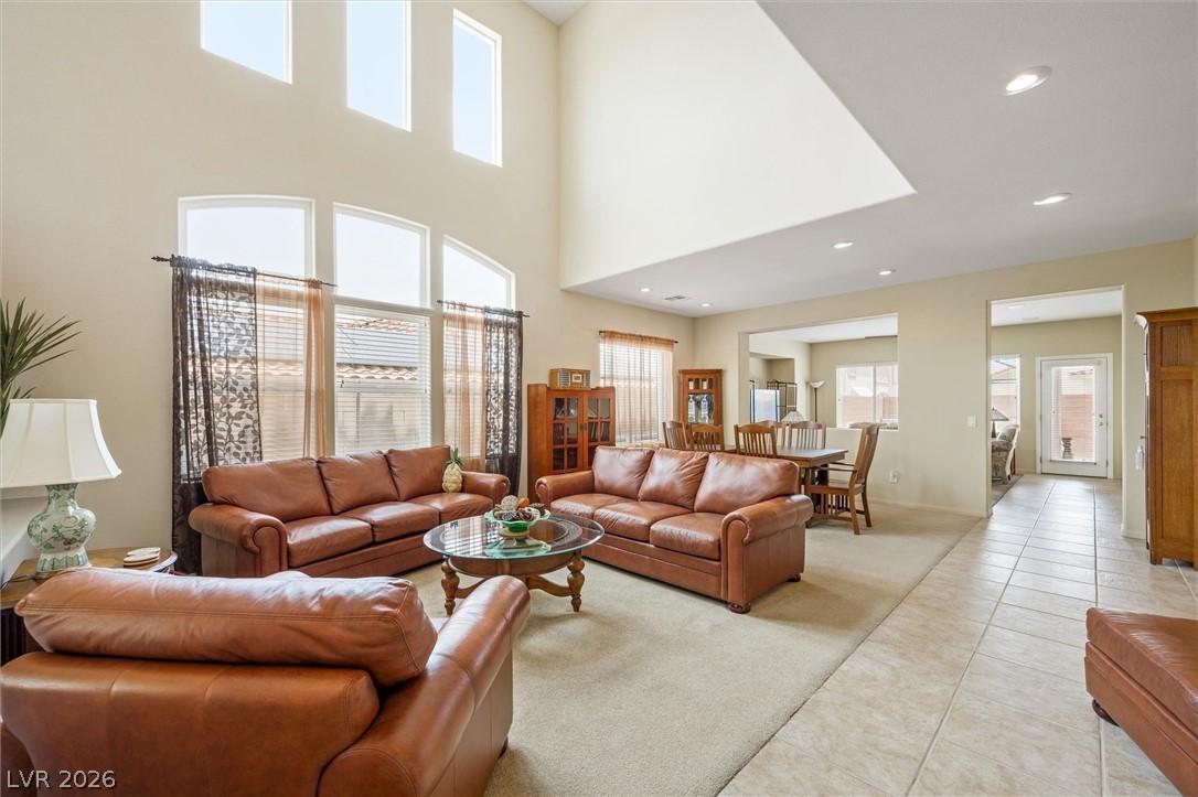 Image 3: A spacious living area features high ceilings and
