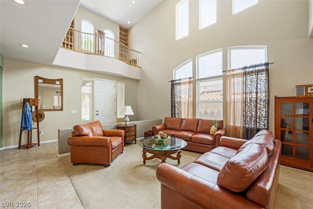 Image 4: A lofty living room features a dramatic two-story