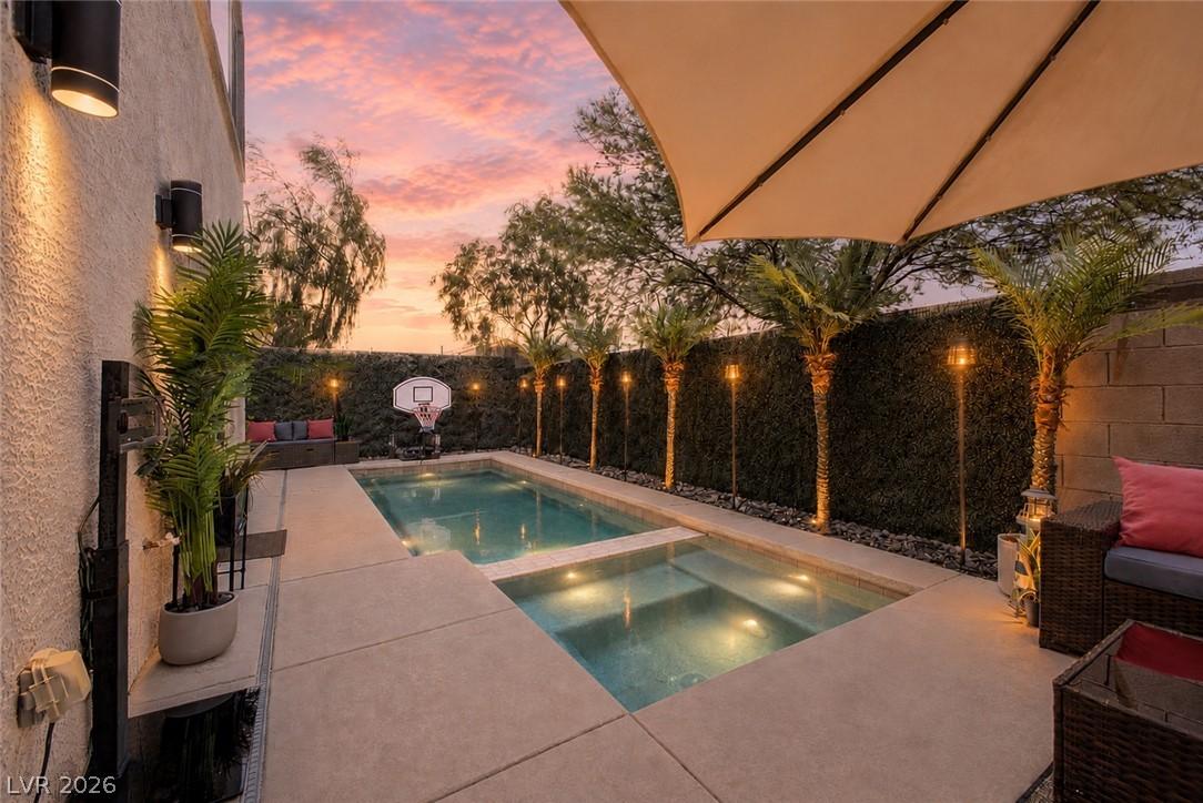 Image 4: An inviting backyard oasis offers a sparkling pool