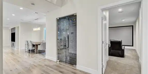 Image 3: Modern wide-plank flooring connects the main livin