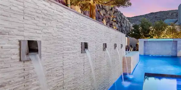 Image 2: Custom stone water features pour directly into a s