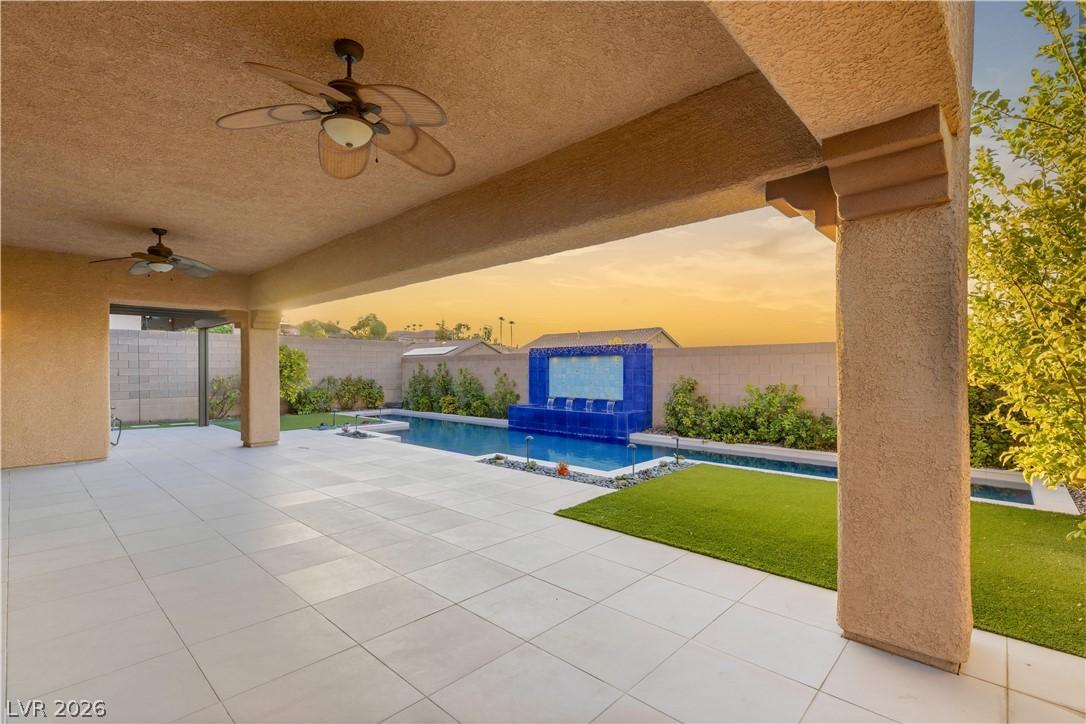 Image 2: An inviting covered patio unfolds to a tranquil po