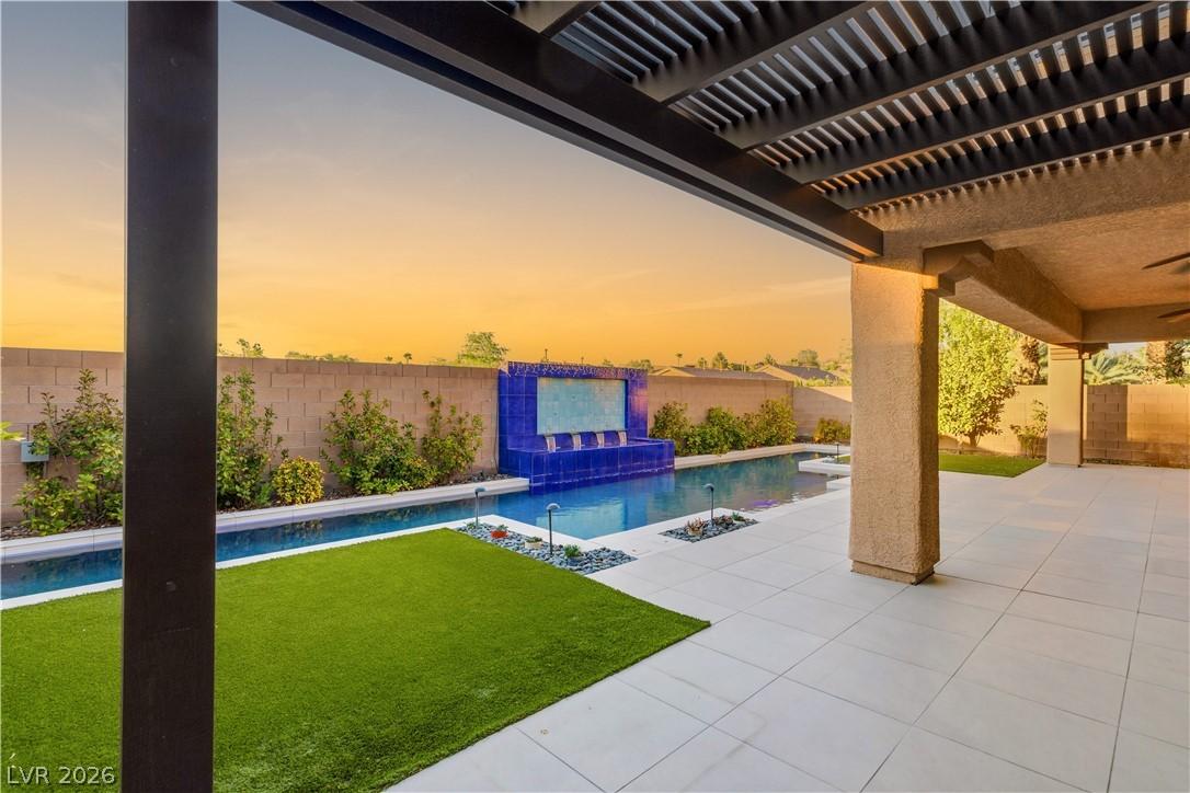 Image 3: An inviting pool area features a captivating tiled